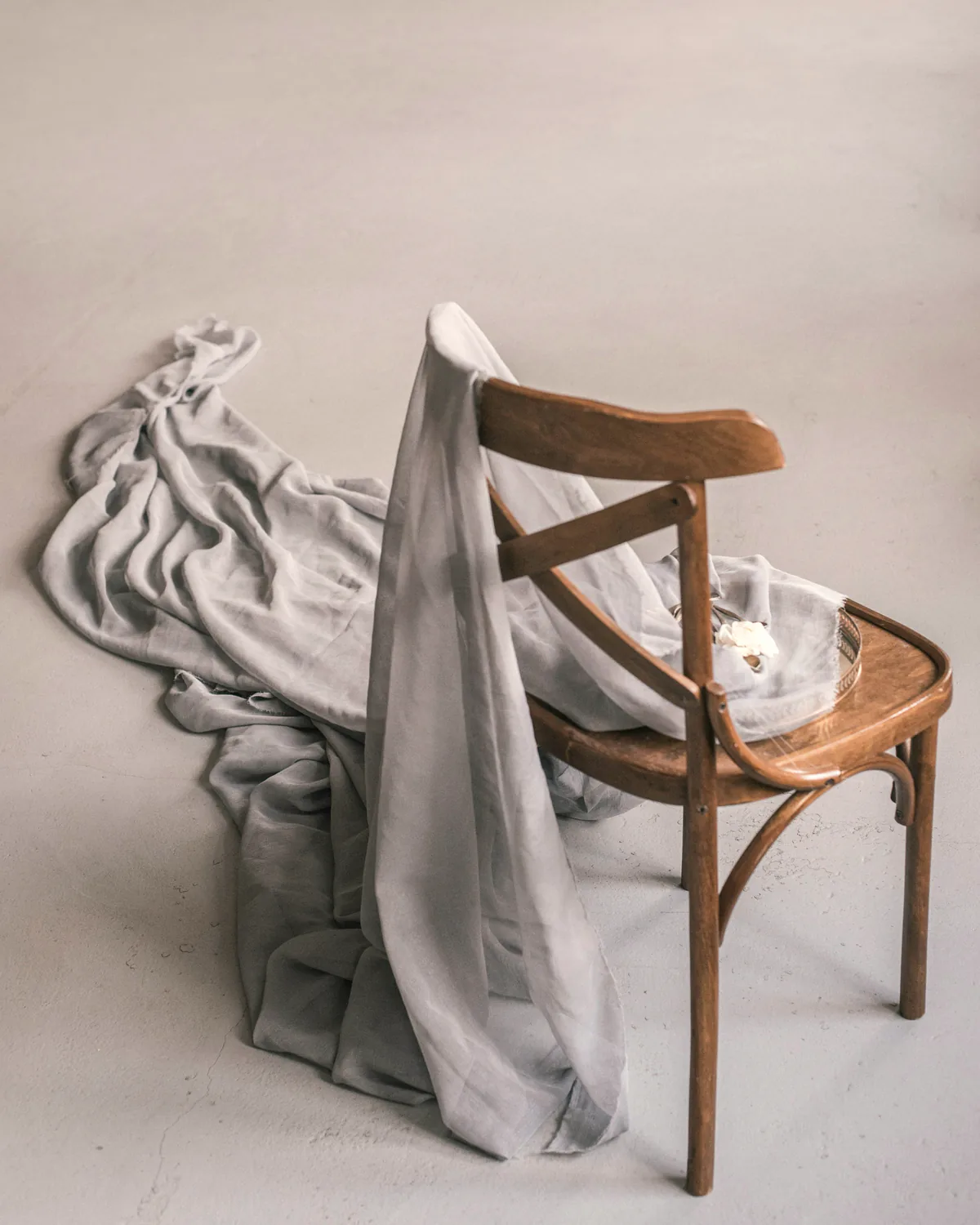 Bentwood chair draped in linen, protected for the journey