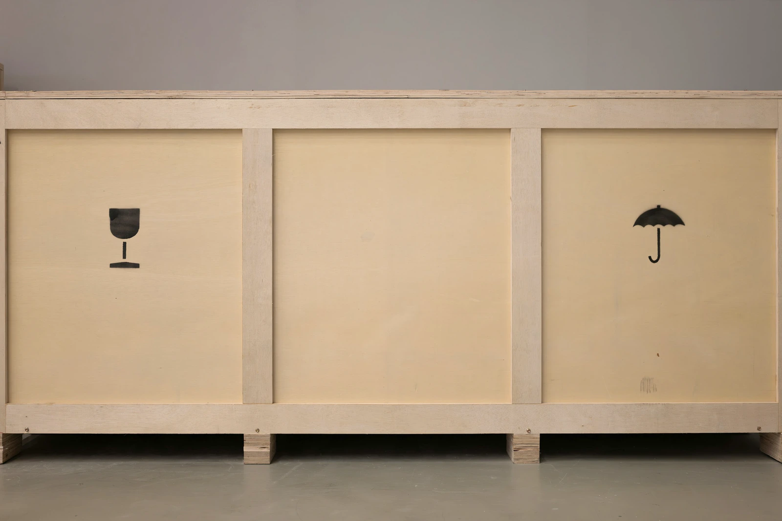 Plywood shipping crate marked fragile and keep dry